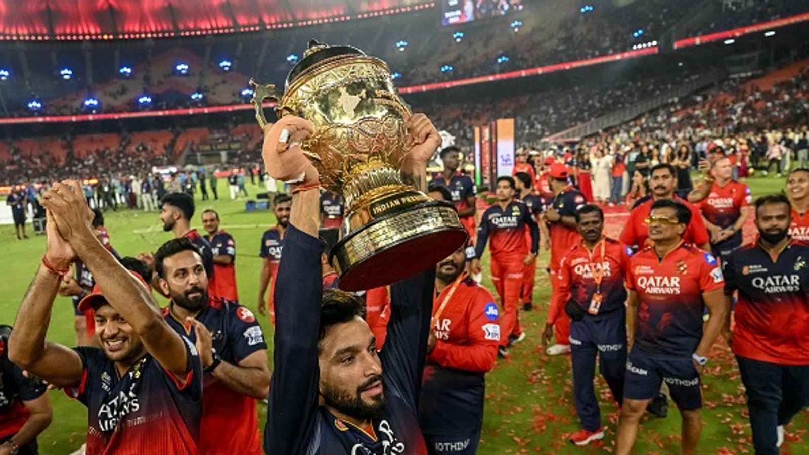 Suspense ends over RCB's two-match home venue for IPL 2026 Royal Challengers Bengaluru's captain Rajat Patidar (C), along with his teammates, takes a victory lap around the field as he celebrates with the trophy (Getty)