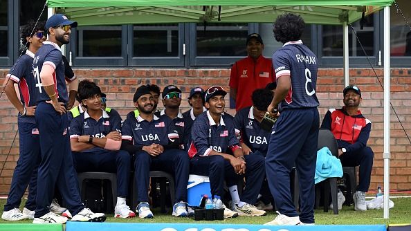 USA cricketers interact as they wait during a delay in play during the U19 World Cup clash against India. (Getty)