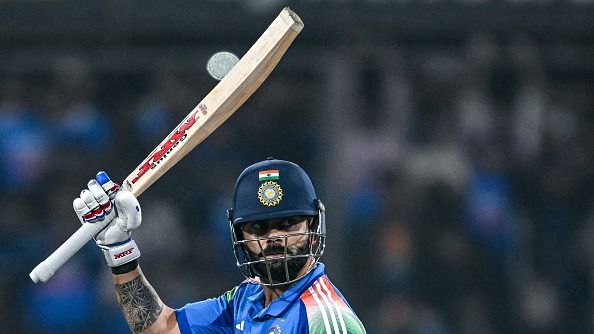 Virat Kohli celebrates after scoring a century (100 runs) during the third one-day international (ODI) cricket match between India and New Zealand at the Holkar Cricket Stadium in Indore (Getty)