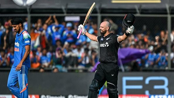  Daryl Mitchell (R) celebrates after scoring a century (100 runs) during the third one-day international (ODI) cricket match between India and New Zealand 