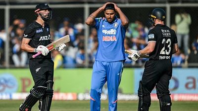 Sunil Gavaskar conducts brutal postmortem of India’s ODI series loss vs New Zealand Harshit Rana (C) reacts as New Zealand's Daryl Mitchell (L) speaks with his teammate Glenn Phillips after hitting a boundry during the third one-day international (ODI) cricket match between India and New Zealand (Getty)