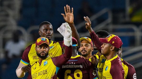 Shai Hope (L) and Jason Holder (2L) of West Indies celebrates the dismissal 