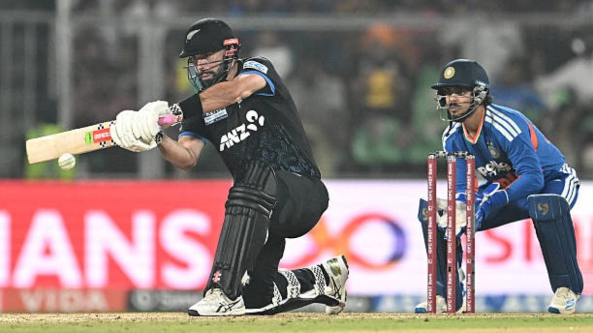 New Zealand's Daryl Mitchell (R) plays a shot as India's wicketkeeper Ishan Kishan watches during the fifth and final Twenty20 international cricket match between India and New Zealand (via Getty)