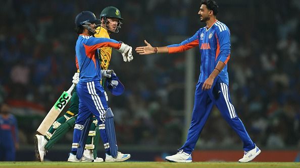 Axar Patel and Ishan Kishan of India celebrate the wicket of David Miller of South Africa with teammates during a warm up match between India and South Africa prior to the ICC Men's T20 World Cup 
