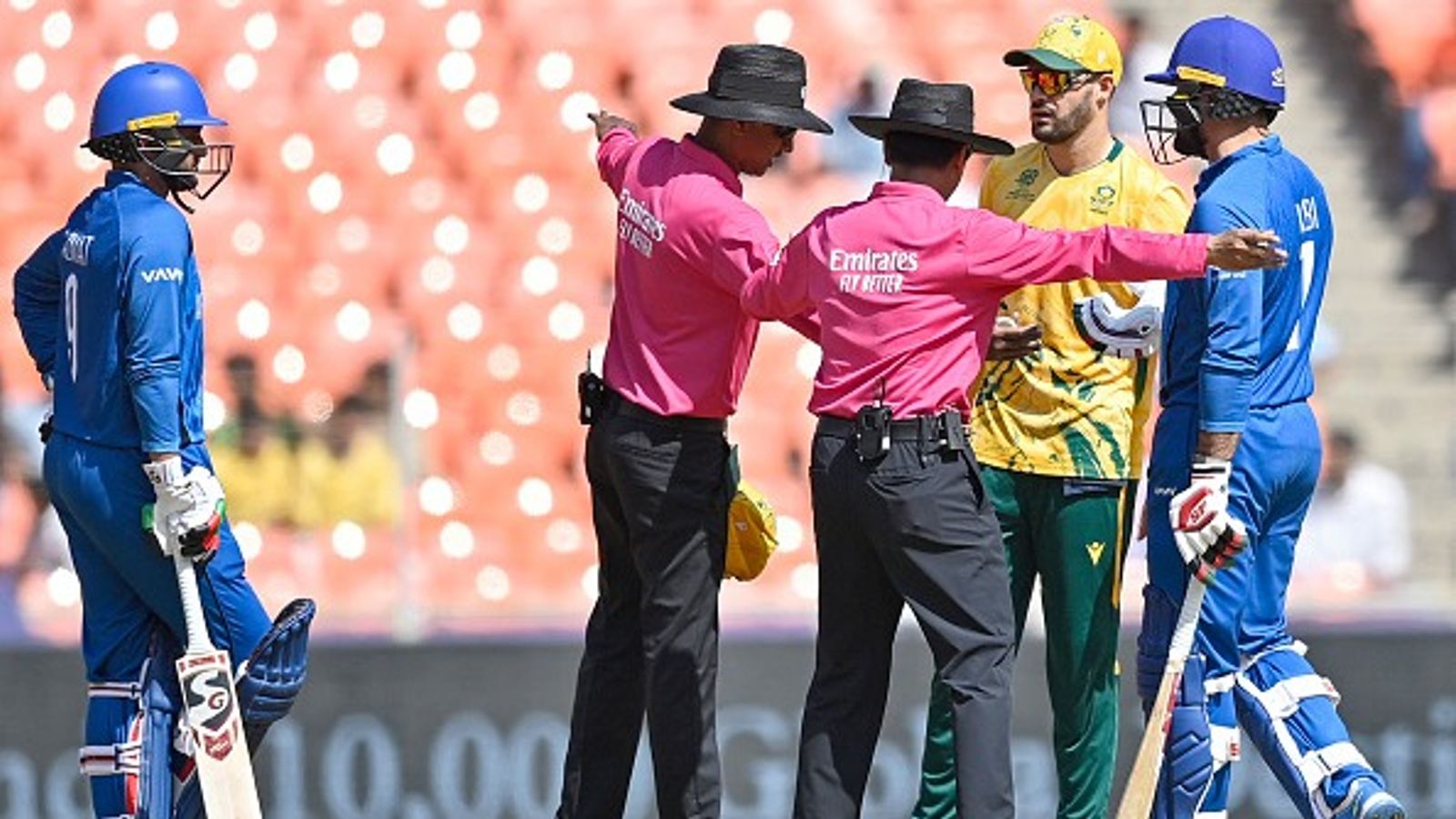 Mohammad Nabi sanctioned by ICC for heated altercation with umpire during double super over clash vs South Africa Afghanistan's Mohammad Nabi (R) and South Africa's captain Aiden Markram (2R) speak with the umpires during the 2026 ICC Men's T20 World Cup group stage match at the Narendra Modi Stadium in Ahmedabad on February 11, 2026.