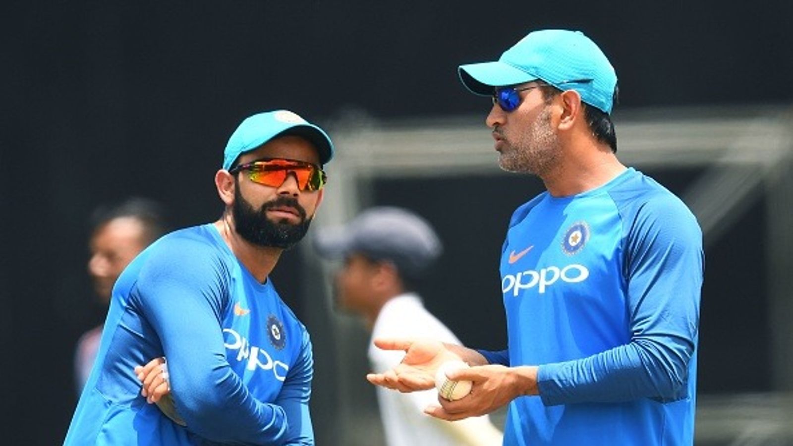 MS Dhoni asked to leave white-ball captaincy, ex-India selector drops bombshell India's captain Virat Kohli (L) listens to teammate MS Dhoni during a practice session at the Queen's Park Oval in Port of Spain, Trinidad, on June 22, 2107, ahead of the first One Day International (ODI) match between West Indies and India (Getty)