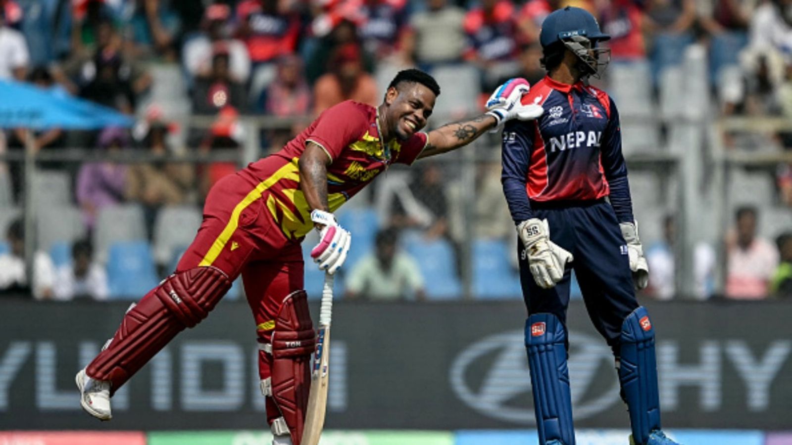 2-time T20 World Cup Champions West Indies knock out Nepal with a dominant 9-wicket win West Indies' Shimron Hetmyer (L) shares a light moment with Nepal's wicketkeeper Aasif Sheikh during the 2026 ICC Men's T20 Cricket World Cup group stage match at the Wankhede Stadium in Mumbai on February 15, 2026.