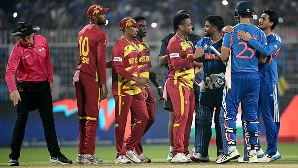 Umpire Alex Wharf gestures as West Indies' Roston Chase, Gudakesh Motie, Shamar Joseph and Shimron Hetmyer congratulate India's Sanju Samson, Shivam Dube and Abhishek Sharma for their team's win (Getty) Umpire Alex Wharf gestures as West Indies' Roston Chase, Gudakesh Motie, Shamar Joseph and Shimron Hetmyer congratulate India's Sanju Samson, Shivam Dube and Abhishek Sharma for their team's win (Getty)