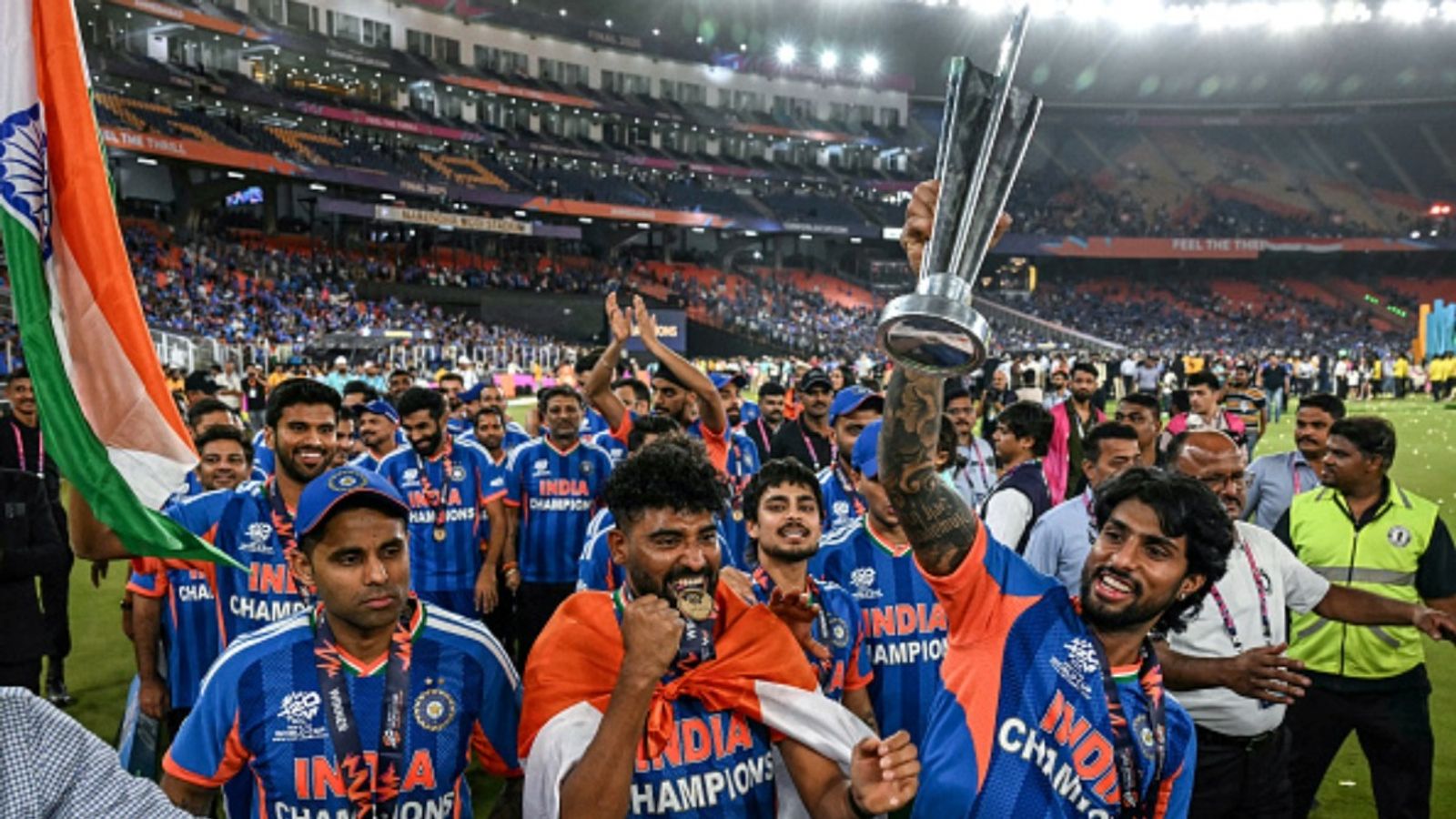 BCCI announces cash reward of Rs 131 crore for Suryakumar Yadav-led T20 World Cup 2026 champions (L-R) India's captain Suryakumar Yadav, Mohammed Siraj, Ishan Kishan and Tilak Varma celebrate with the trophy during a victory lap after winning the 2026 ICC Men's T20 World Cup final at the Narendra Modi Stadium, Ahmedabad on March 8, 2026.