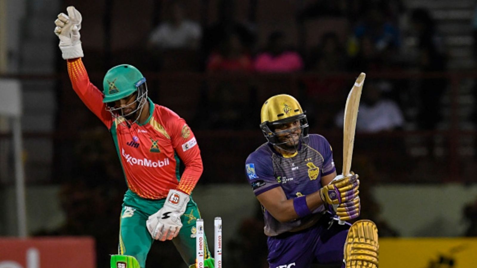 Ex-KKR pacer and 2 others face provisional suspension over match-fixing charges in Bim T10 tournament Javon Searles (R) of Trinbago Knight Riders is bowled as Nicholas Pooran (L) of Guyana Amazon Warriors celebrate during match 30 of the CPL at Guyana National Stadium on October 4, 2019 in Providence, Guyana.