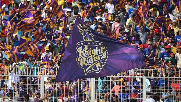 Fans of Kolkata Knight Riders wave a flag to support the team. (Getty)