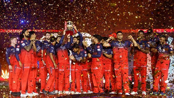 Virat Kohli and Rajat Patidar of Royal Challengers Bengaluru lift the IPL 2025 trophy alongside teammates in this frame. (Getty)