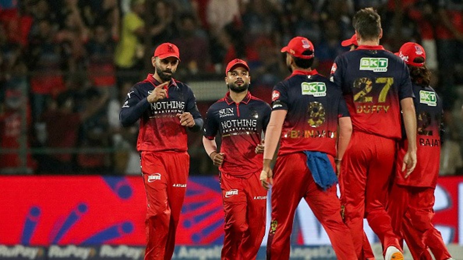 'Not here with the mindset that we have to defend...': Rajat Patidar reveals RCB's blueprint for IPL 2026 Virat Kohli (L) celebrates with teammates after the dismissal of Sunrisers Hyderabad's Indian cricket player Abhishek Sharma during the 2026 Indian Premier League (IPL) T20 match between Royal Challengers Bengaluru and Sunrisers Hyderabad (Getty)