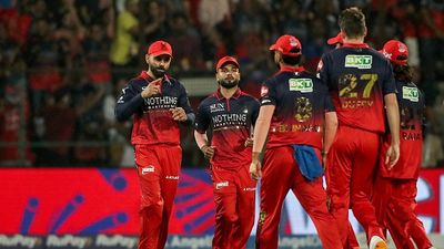 'Not here with the mindset that we have to defend...': Rajat Patidar reveals RCB's blueprint for IPL 2026 Virat Kohli (L) celebrates with teammates after the dismissal of Sunrisers Hyderabad's Indian cricket player Abhishek Sharma during the 2026 Indian Premier League (IPL) T20 match between Royal Challengers Bengaluru and Sunrisers Hyderabad (Getty)
