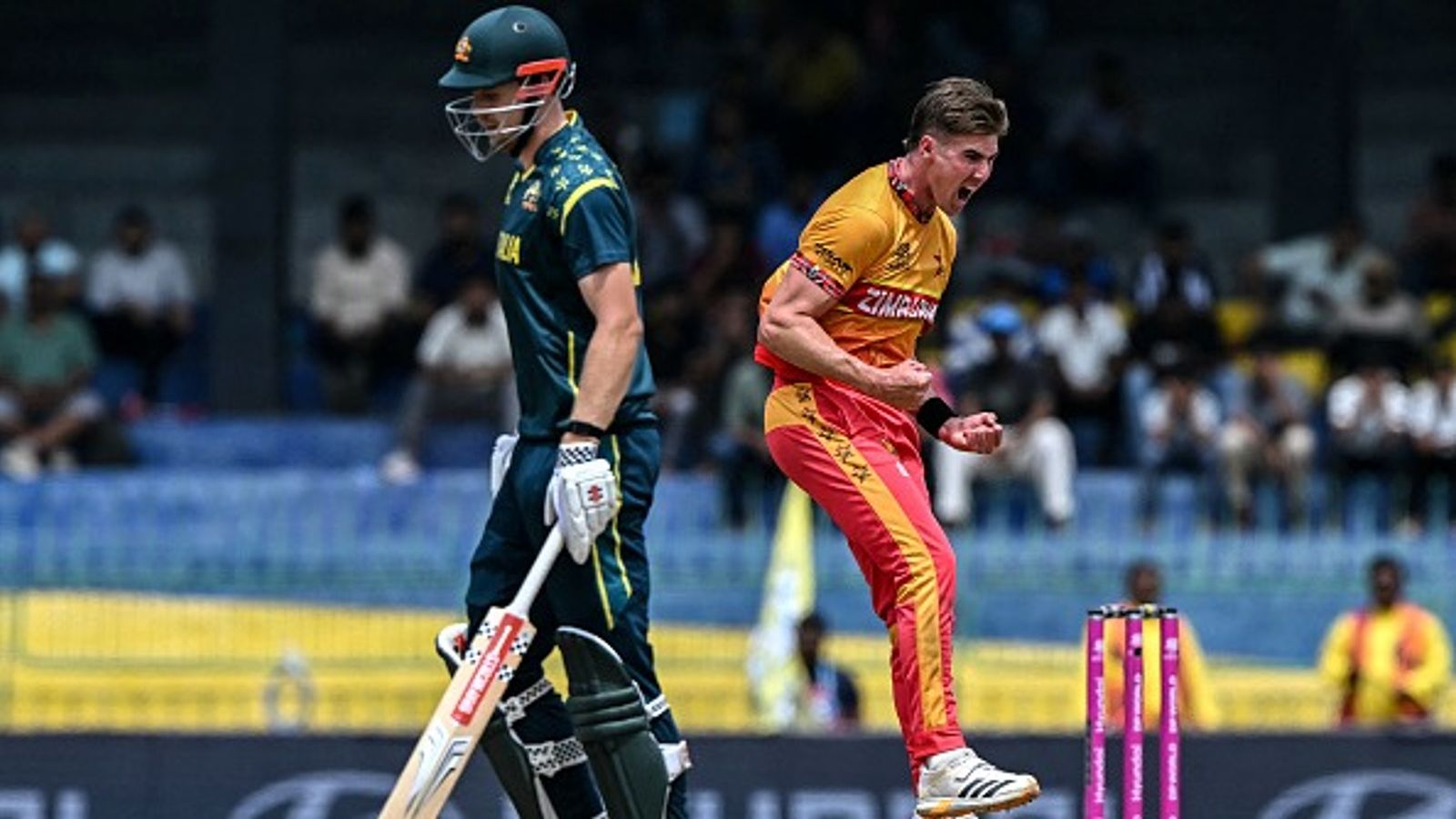 Stunned in T20 WC'26, Australia to tour Zimbabwe to avoid similar result in ODI WC'27 Zimbabwe's Brad Evans (R) celebrates after taking the wicket of Australia's Cameron Green (L) during the 2026 ICC Men's T20 World Cup group stage match at the R Premadasa Stadium in Colombo on February 13, 2026.