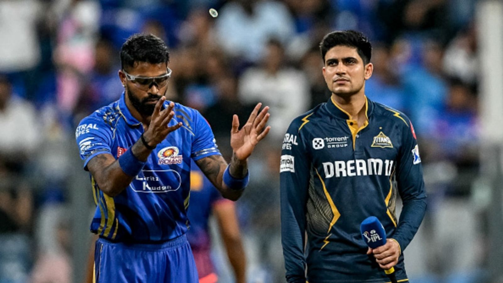 Gujarat Titans vs Mumbai Indians Live Streaming: Match Details, Team Prediction & Pitch Report Mumbai Indians' captain Hardik Pandya (L) tosses the coin as his Gujarat Titans' counterpart Shubman Gill watches before the start of the IPL match at the Wankhede Stadium in Mumbai on May 6, 2025.