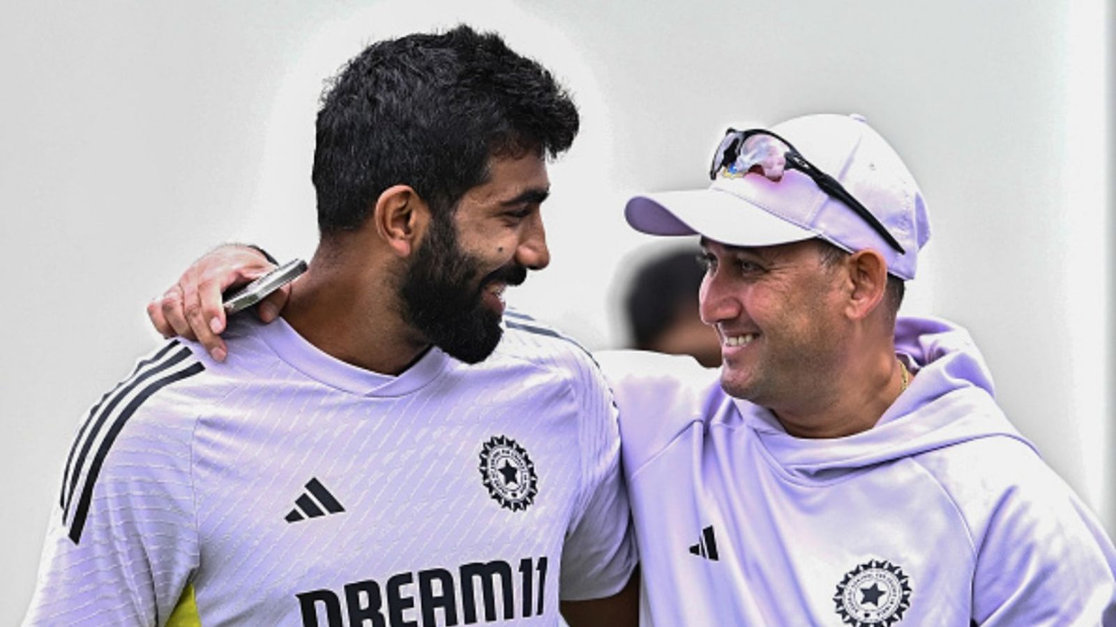 'Selectors don't want to distribute Test caps so easily': BCCI in dilemma over testing new pacers for one-off Afghanistan Test - Report Jasprit Bumrah (L) and Chief Selector Ajit Agarkar (R) of Team India seen during a net practice session at the Sydney Cricket Ground.