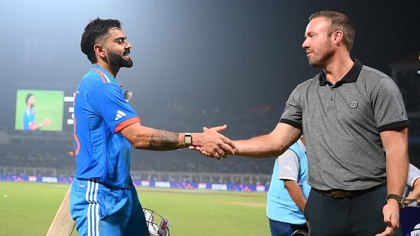 Virat Kohli of India interacts with AB de Villiers as they make their way off after finishing unbeaten on 101 after equalling Sachin Tendulkar's record