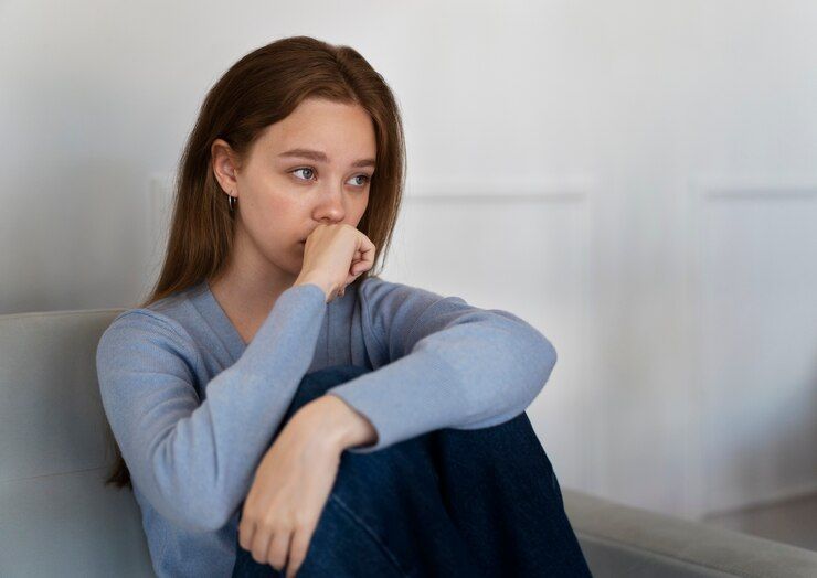 side view worried woman sitting couch 23 2149450376