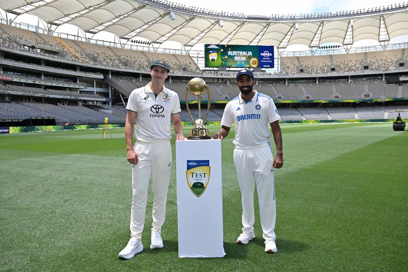 Cricket Captains Bumrah and Cummins pose with trophy